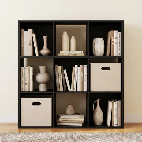 Matte black cube shelf styled with books, vases and cream fabric bins