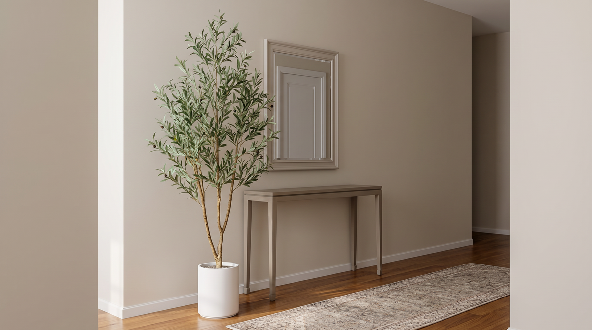 Faux olive tree in a tall white planter beside an entryway console