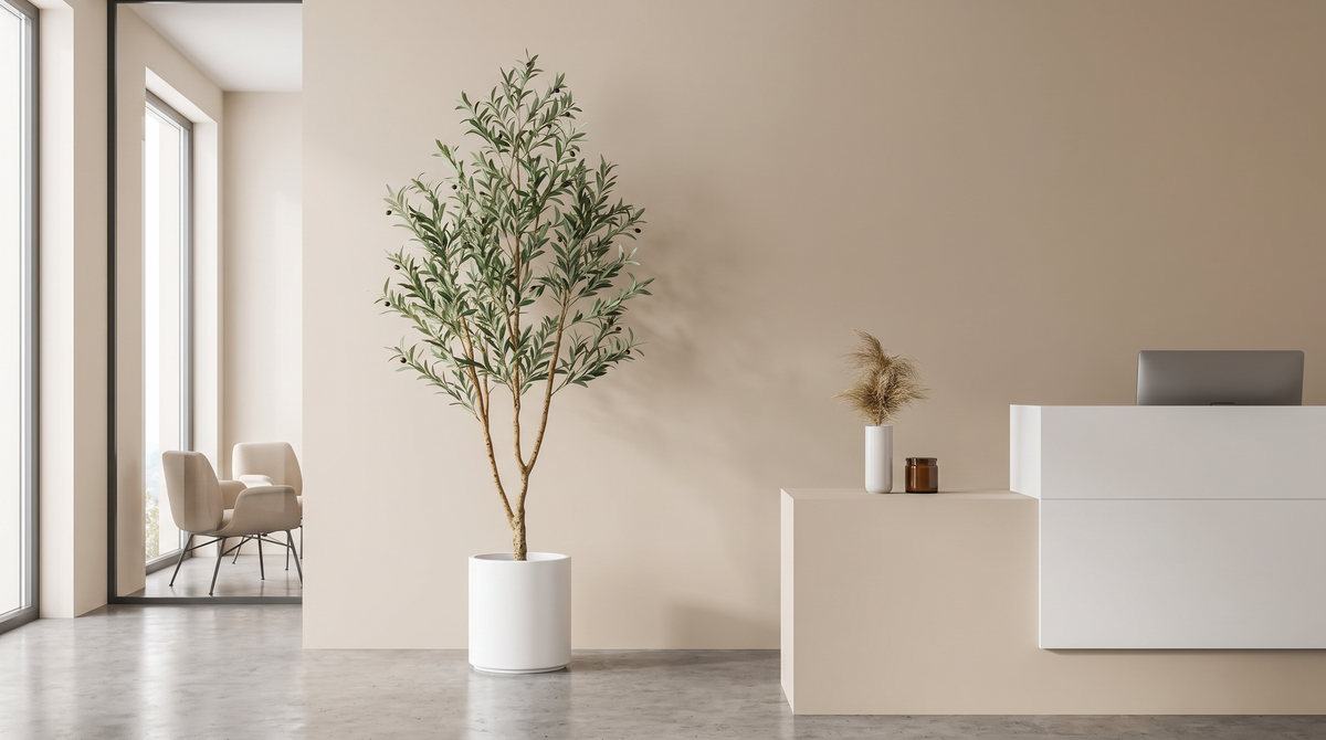 Faux olive tree in a tall white planter in a modern office reception