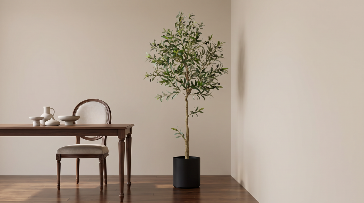 Faux olive tree in a black pot in a dining room corner
