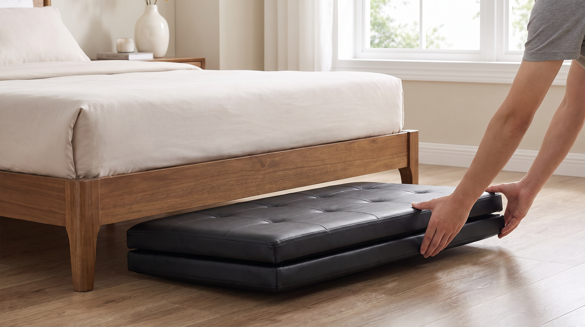Folded flat storage ottoman being slid under a bed