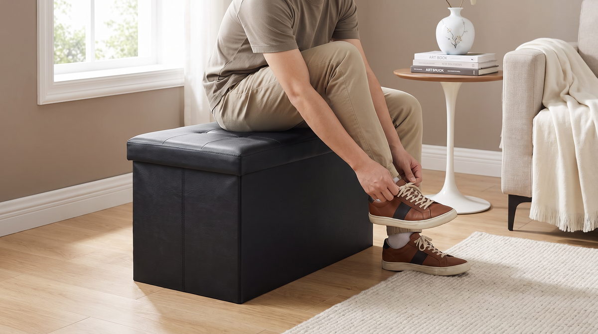 Person sitting on the closed lid of the storage ottoman