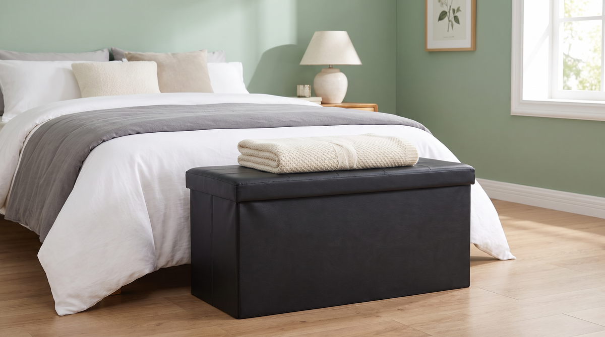 Storage ottoman used as a bench at the foot of a bed