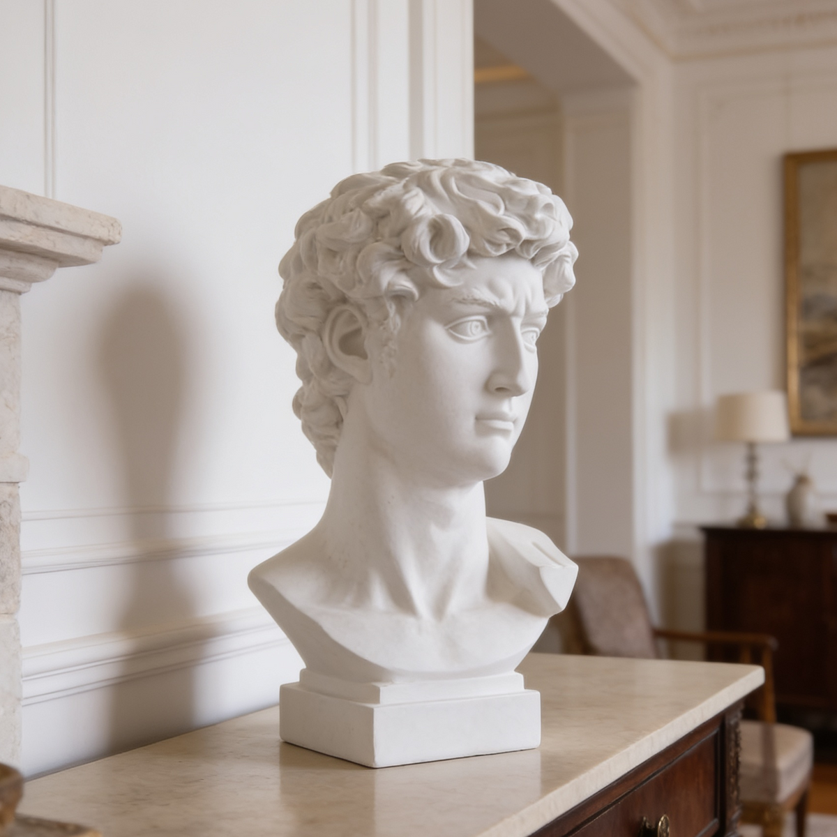 Matte white David bust on a plinth atop a marble console in a paneled room