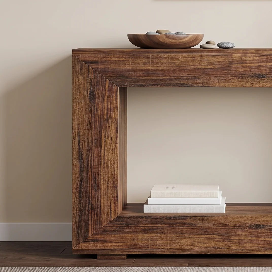 Rustic wood console with an open mitered frame holding a bowl and books