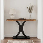Rustic wood console with a white lamp and dried stems above a patterned runner