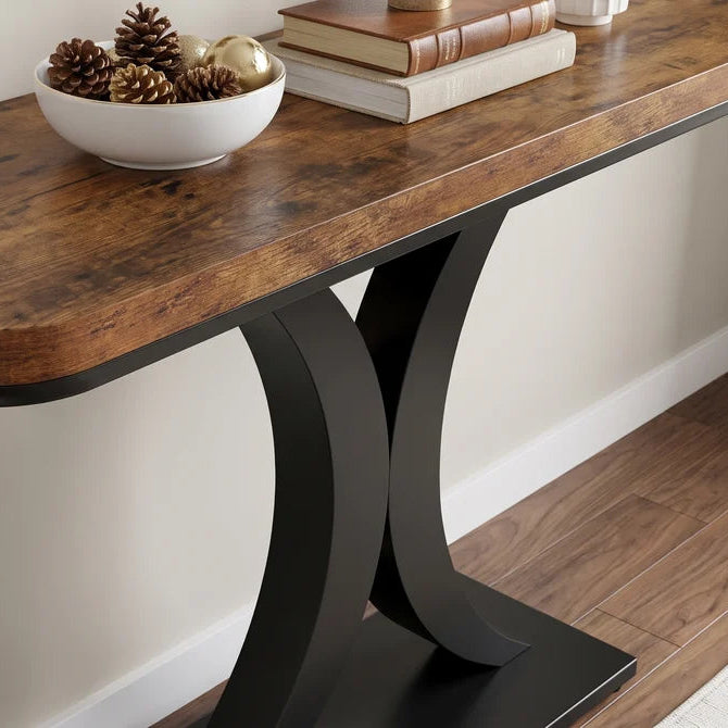 Detail of the rustic table top edge and the curved black leg below it