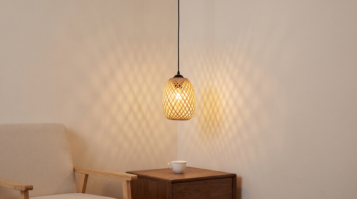 Woven bamboo barrel pendant casting a patterned glow on a wall