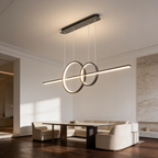 Gold linear bar pendant with two crossing rings above a dining table