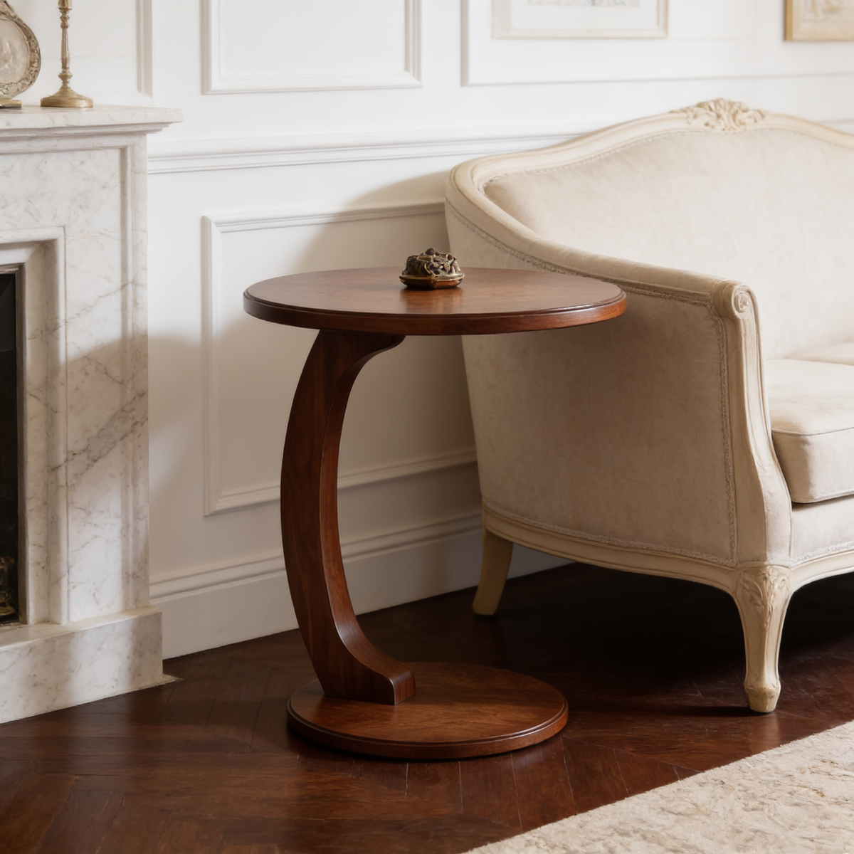 Close view of the round wood side table tucked beside an upholstered armchair