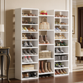 Tall white shoe rack of open cubbies filled with shoes and boots in a hallway
