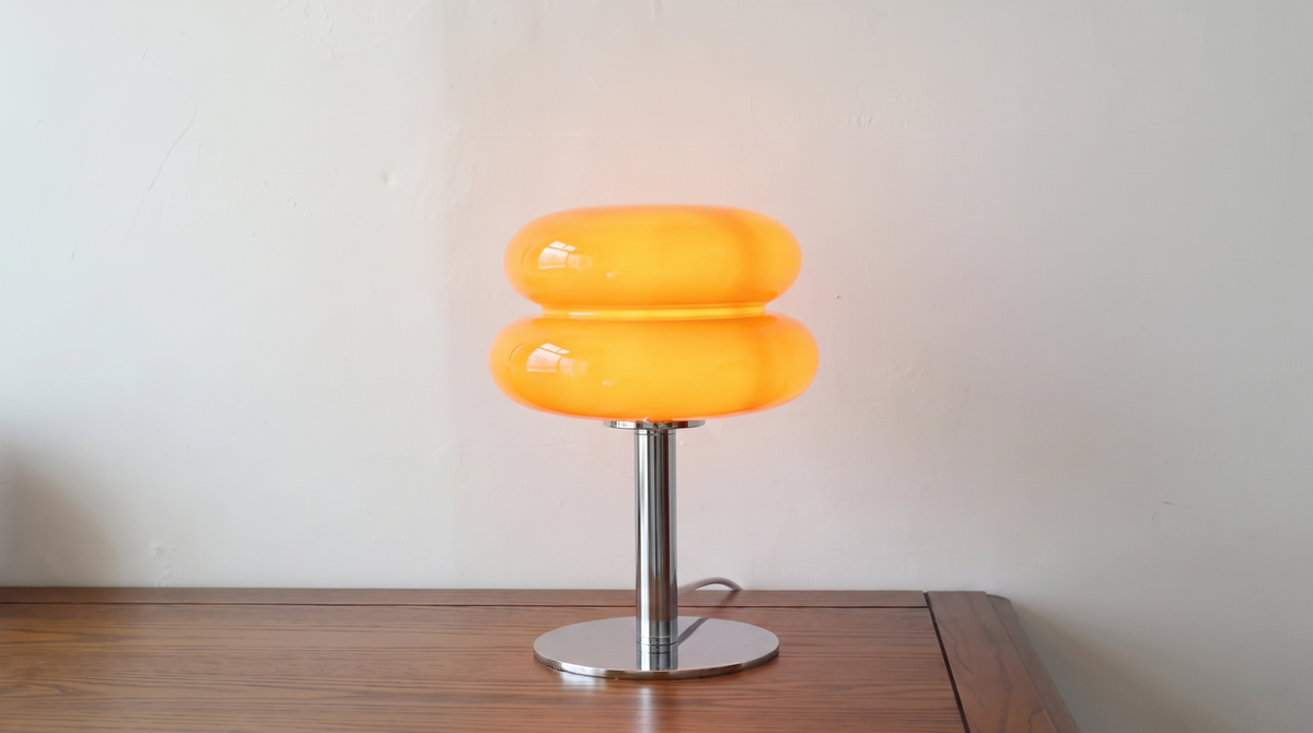 Close profile of the two stacked glass discs of an orange macaron lamp