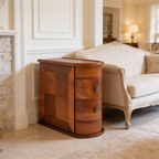 Compact wood end table next to an armchair in a bright living room