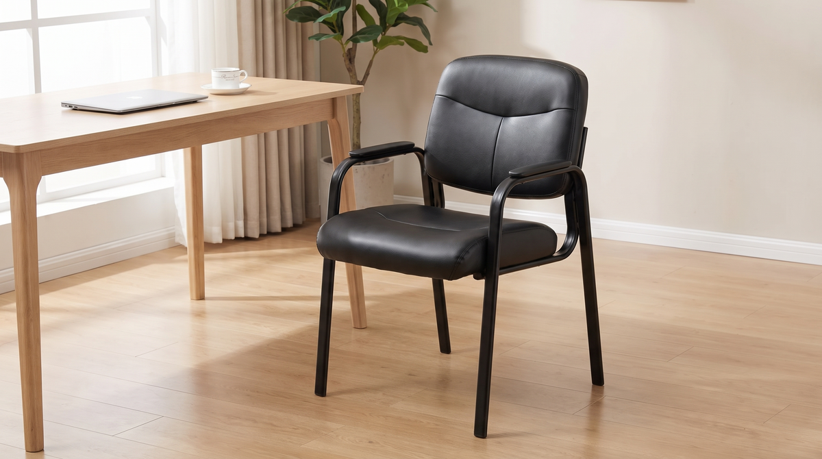 Black padded guest chair on the visitor side of a desk