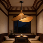 Two woven straw hat pendants lit in a room with a dark wood ceiling and window