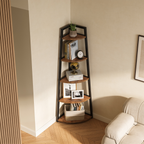 Tall corner ladder shelf next to a cream armchair and a slatted wood wall