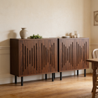 Pair of slatted door cabinets against a cream wall below framed art
