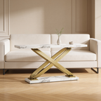 Faux marble console table on a gold metal X base standing behind a cream sofa