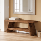 Entryway bench with folded linens on the seat in a bright hall by a mirror