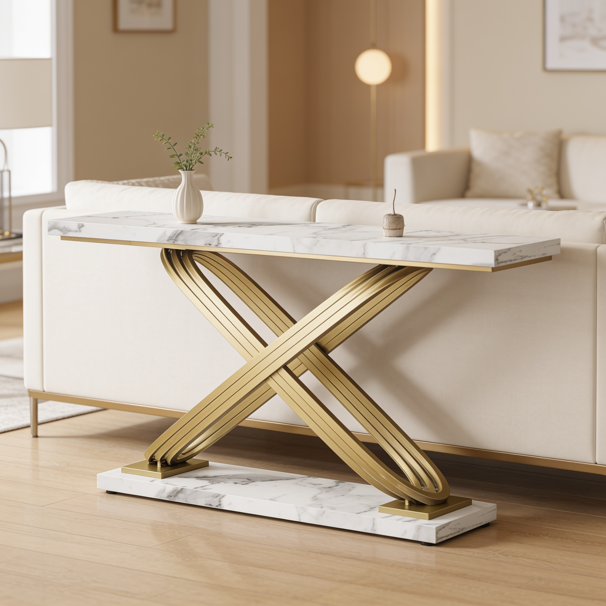 Marble top console with crossed gold legs along a living room wall by a sofa