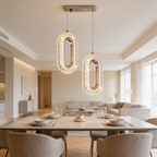 Three oblong crystal ring pendants hung over a round dining table