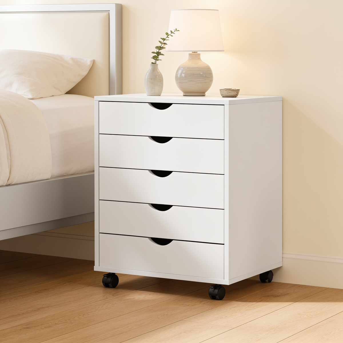 Side view of the drawer cabinet against a white headboard with a vase on top