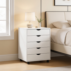 Wheeled bedside chest by a window in a room with cream bedding