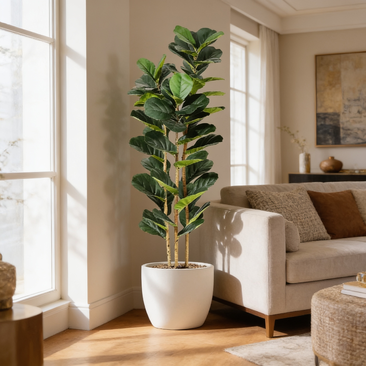 Faux fiddle leaf fig in a white pot by a window with a beige armchair