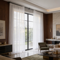 Sheer white panels along a wall of windows in a wide living room