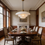 Cream opal glass pendant lit above a round dining table in a paneled room