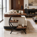 Curved black frame side table slid over a cream sofa arm with cups on the walnut top