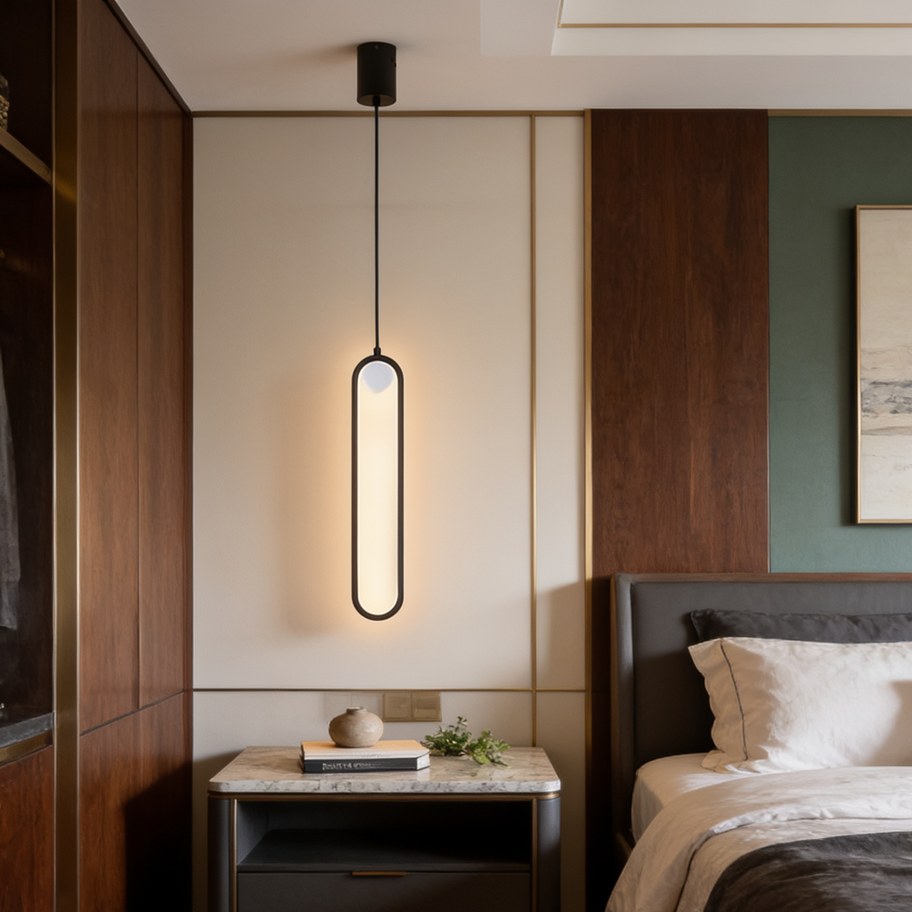 Black oval ring pendant glowing warm above a nightstand beside a wood paneled bed