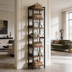 Skinny bookcase filled with books and decor in a room with a green sofa