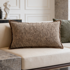 Taupe ribbed lumbar pillow next to an olive cushion on a light sofa