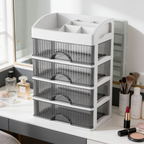 Makeup drawer tower with brushes in the top compartments near a mirror