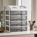 Clear five drawer makeup organizer standing empty on a vanity