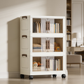 Cream three tier cabinet with clear doors holding books and boxes in a bedroom