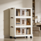 Cream three tier cabinet with clear doors holding books and boxes in a bedroom