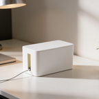 White power strip case on a pale desk with a single cable trailing away