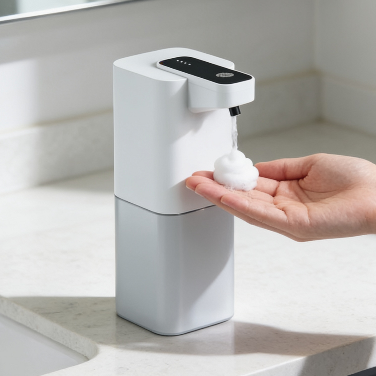 Touchless pump dropping a foam dome into an open palm on a stone counter