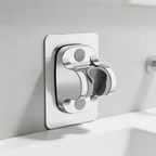 Chrome adjustable shower head holder mounted on a tiled wall