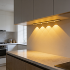 Under cabinet light over a wood counter with the range visible beyond