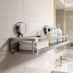 Suction rack holding folded towels and pump bottles next to a bathroom mirror