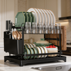 Angled view of the black dish rack draining beside a stainless sink on marble