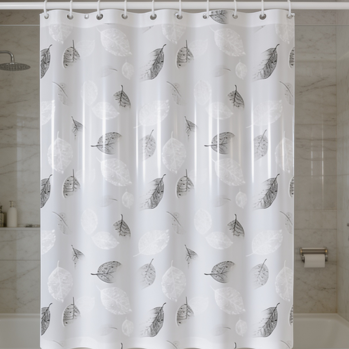 Leaf print bath curtain pulled closed across a shower alcove next to a toilet