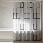 Close view of the black rectangle pattern bath curtain hanging above a white tub