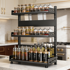 Black three tier spice rack filled with jars and bottles on a countertop