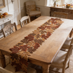 Fall maple leaf runner on a dining table with chairs facing a bright window