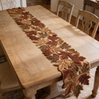 Autumn leaf runner stretched down the length of a bare wood table