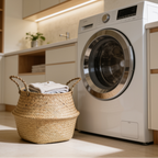 Seagrass belly basket of laundry beside a front loading washer